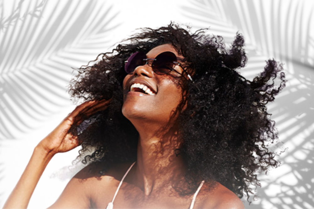 girl enjoying sunshine without fear of damaging her hair because of mielle organics hair products.