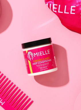 Mielle Organics product with comb on pink background