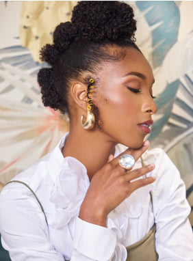 Woman with styled hair using Mielle Organics products for healthy hair.