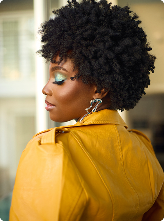 Model showcasing healthy, nourished hair using Mielle Organics products.