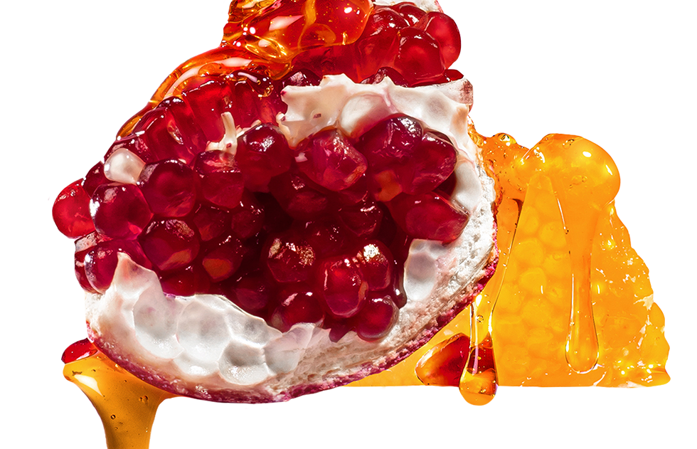 Pomegranate with white cream and honey on a white background