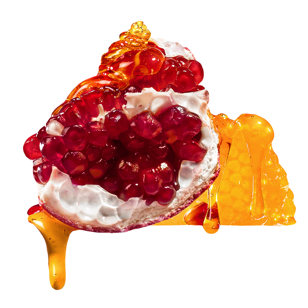 Pomegranate with white cream and honey on a white background