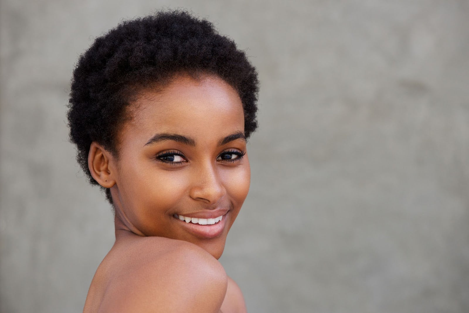 Close up beauty portrait of young african short haired woman smiling