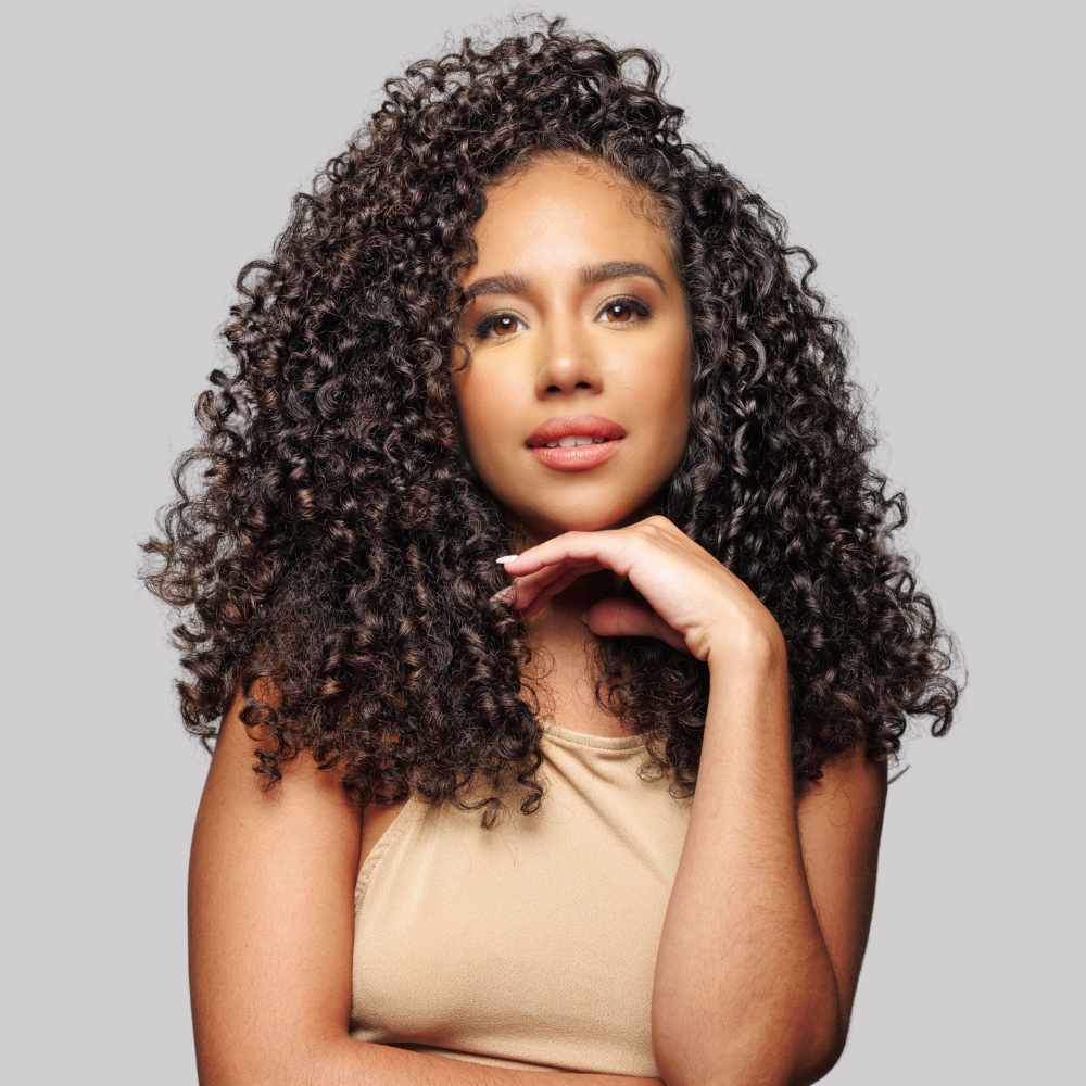 model with wavy hair and representing natural hair products for wavy hair type
